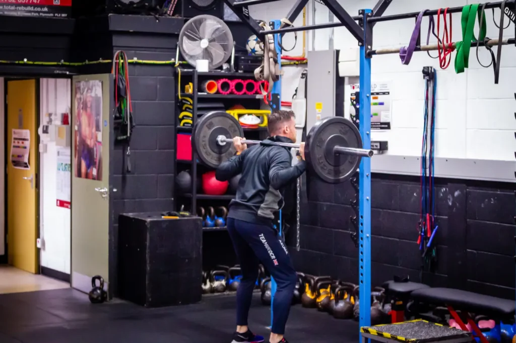 Barbell back squat lockout position with full hip and knee extension