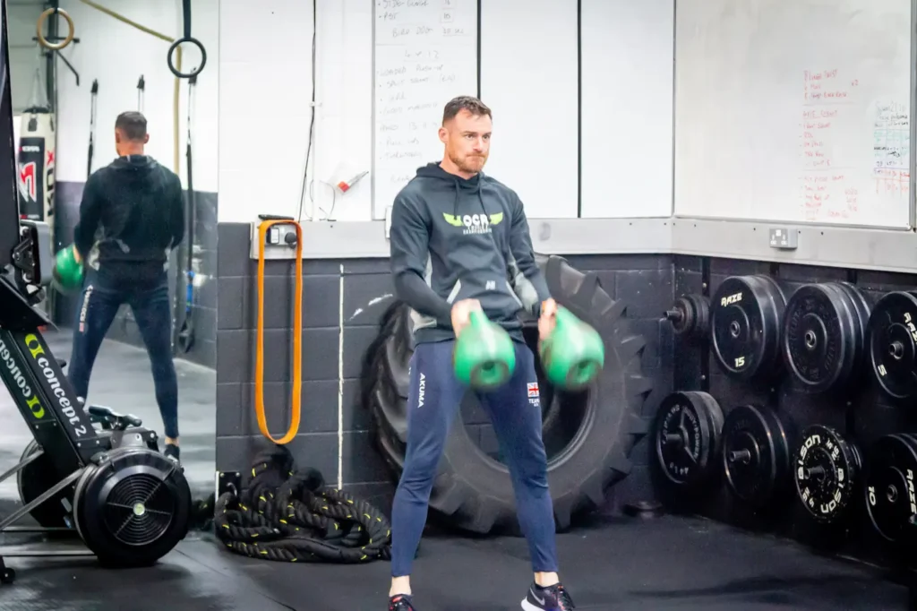 Kettlebells floating upward during clean with elbows beginning to rotate through