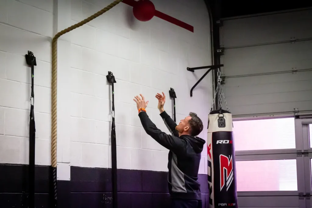 Medicine ball contacting a wall during an overhead squat throw